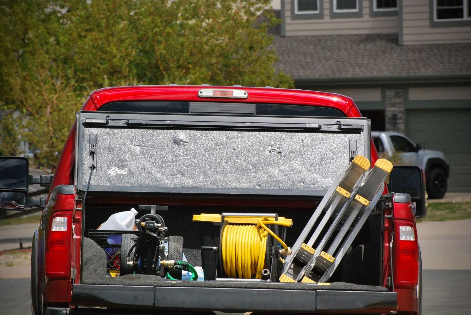 Fully-outfitted Prime Home Windows truck — pure-water system, hose reel, and ladders